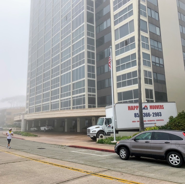 Happy Home Moovers truck outside a high-rise building during a move